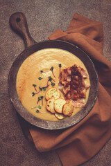 Pumpkin cream soup, curry, fried bacon, bruschetta chips,micro-greens, top view, no people,