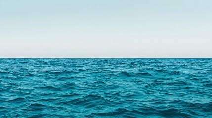 Fototapeta premium Vibrant Teal Water Waves Meeting Soft White Sky: A Serene Ocean View Landscape for Backgrounds and Design.