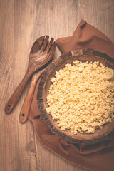 cooked couscous, in a wooden bowl, top view, no people,