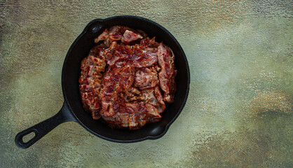 Crispy bacon, in a cast-iron skillet, rustic style, no people