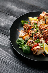 Chicken kebab skewers on a plate with vegetables. Mediterranean healthy food