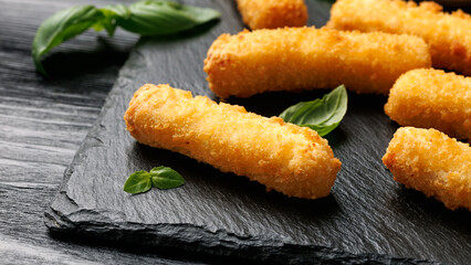 Crispy Halloumi cheese sticks with tomato sauce.
