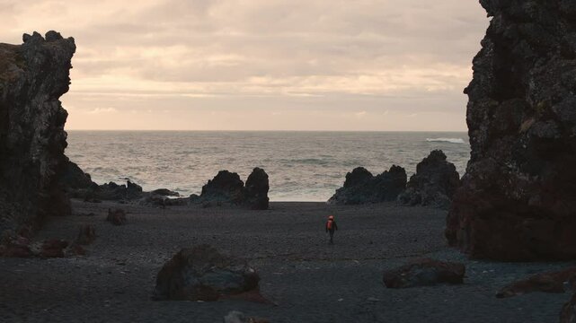 Man Exploring and Photographing Iceland&rsquo;s Black Sand Beach