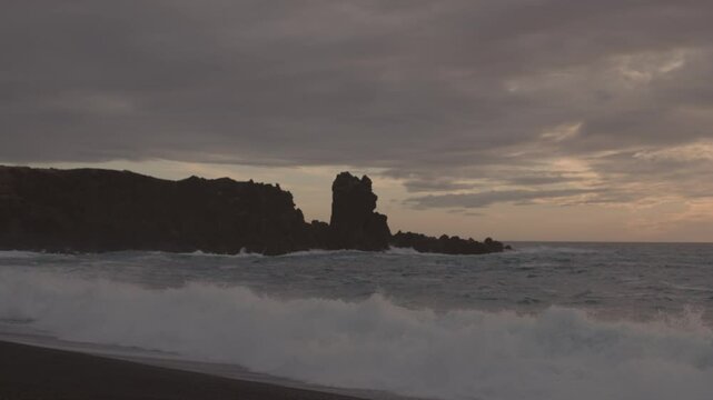 Man Exploring and Photographing Iceland&rsquo;s Black Sand Beach