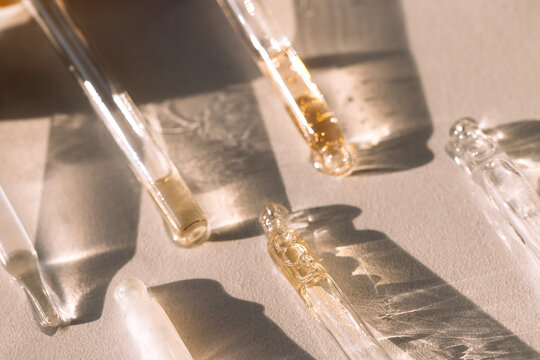 Close-up of glass pipettes with moisturizing serum with colloidal gold.