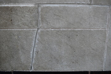Fototapeta premium Cracked stone tiles on side of government building.