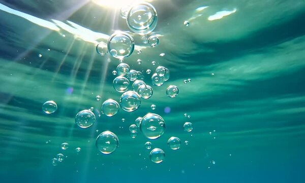 Underwater slow motion bubbles moving to surface in turquoise crystal clear pool