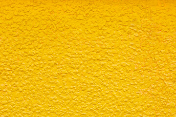 Bright Yellow Rough Textured Wall Close-up Background