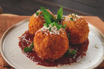 Crispy Arancini appetizer, with parmesan cheese and microgreens, plate, tomato sauce, homemade, no people,