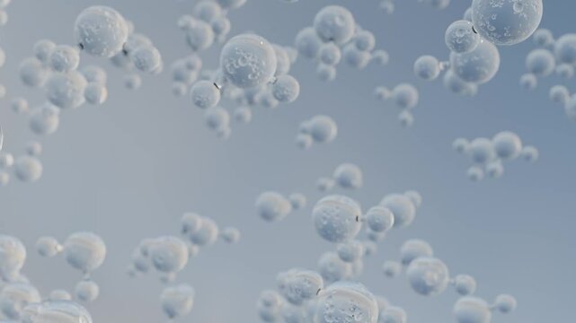 Water molecules rising in front of blue background. Floating H2O droplets seamless loop.