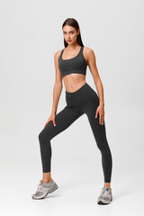 Fitness woman. Athletic girl on the gray background