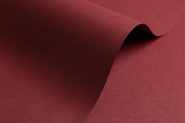 Matt paper texture with bold dark wine red and burgundy tones, sleek wavy design and curved edges,...