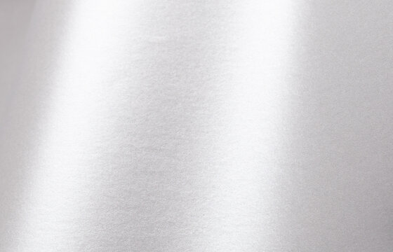 Silver paper texture with pearlescent gloss, shimmering surface and metallic platinum tones, sleek wavy effect with a modern, minimalistic design, luxurious bright finish and elegant contrast for a.