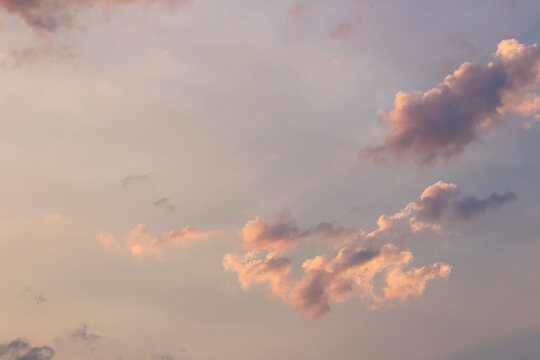 cumulus clouds on the sky blown by the wind. meditation at dusk. cloudy weather meteorology background in orange glow. evening mood
