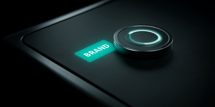 Dark metallic surface with illuminated button displaying "BRAND", showcasing concept of brand activation or technological branding, ideal for business or technology websites