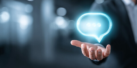 Glowing cyan speech bubble hovers above an outstretched hand, symbolizing communication, support, or online interaction