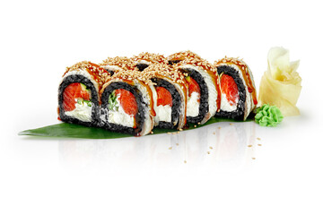 Black sushi rolls with salmon, cream cheese and sesame seeds on green leaf
