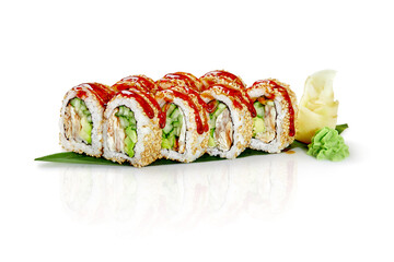 Sushi rolls with sesame seeds, unagi sauce, cucumber, avocado and fish on banana leaf resting on white background