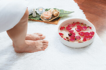 Woman indulges in blissful foot massage at luxurious spa salon while masseur give reflexology therapy in gentle day light ambiance resort or hotel foot spa. Quiescent