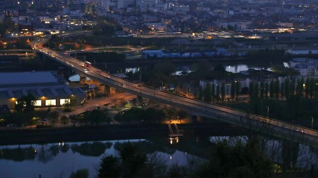 ROUEN, NORMANDY, FRANCE: timelapse and aerial view of highway bridge over Seine river with vehicles traffic at night