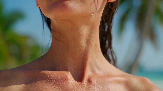 Close-up of beautiful woman's collarbones under sunlight at a tropical beach