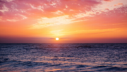 Obraz premium beautiful orange pink sunset over the sea background image
