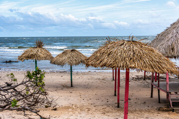 Colorful waters and natural-framed kiosks at Pesqueiro Beach, Soure in Marajo Island, Brazil