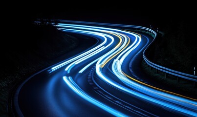 Fototapeta premium Long exposure of winding road with light trails from passing vehicles at night