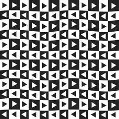 Black and white triangles arranged in a checkered grid. Checkered and vawy pattern with triangles.