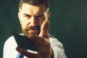 Banker or businessman with credit, debit or payment card. Online shopping, money, finance, cashless payment. Banking service. Handsome bearded man with business card or visiting card. Selective focus.
