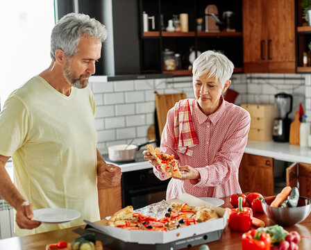 love kitchen senior woman man couple home retirement happy food smiling husband wife together pizza tasting fast food