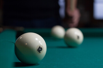 Russian billiards white balls on table cloth and player