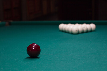 Russian billiards:  red and white balls on green game table