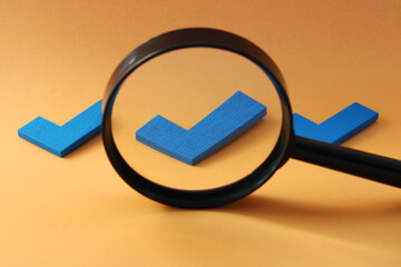 Magnifying glass selecting one of three check marks