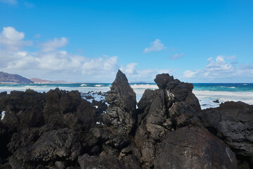 Caleta del Mojon Blanco beach on Atlantic Ocean with volcanic relief, big sharp rocks, big waves in Lanzarote, Spain