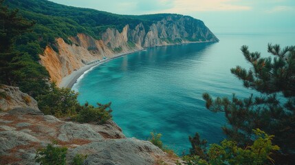 Scenic coastal view showcasing cliffs and turquoise waters under a cloudy sky