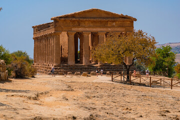 Tourists exploring Valley of the Temples (Valle dei Templi) Temple of Concordia, Agrigento, Sicily, Italy. Travel and sightseeing journey concept