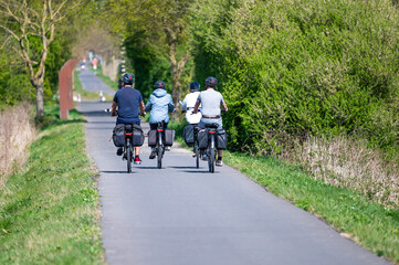Obraz premium E bike cyclists driving the Vredes fietsroute cycling trail in Langemark - Poelkapellen, Ieper, West Flanders, Belgium