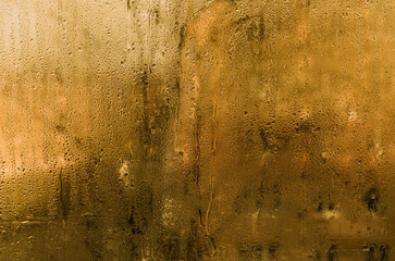 wet glass background. Warm humidity creates condensation on cold window glass. Droplets form artistic patterns