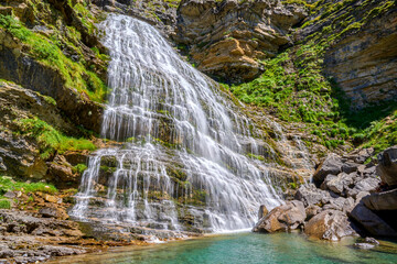Spectacular Cola de Caballo waterfall, in the valley of the Ordesa and Monte Perdido National Park, Pyrenees, Spain.