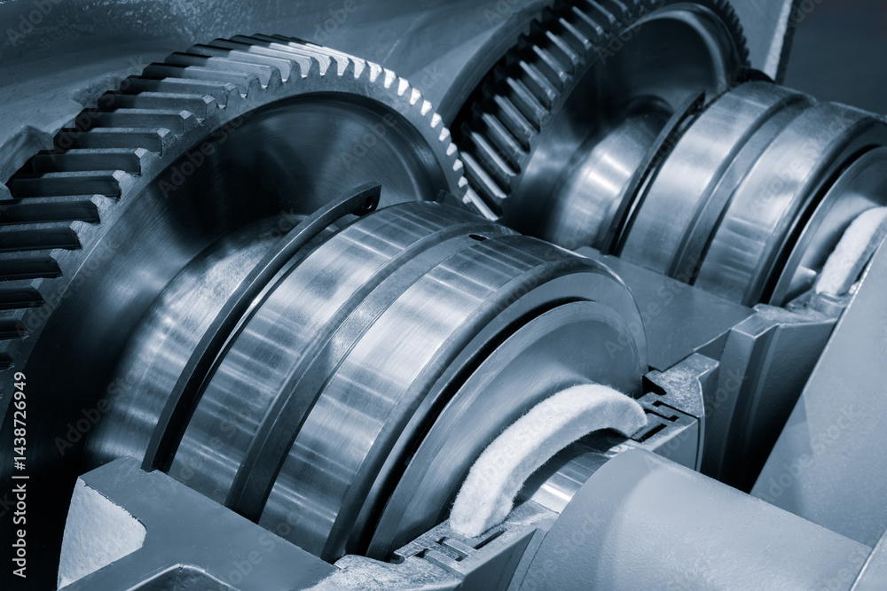 Aufkleber A close-up of a machine with several gears, including a large one in the center. The gears are made of metal and appear silver. Industrial concept background