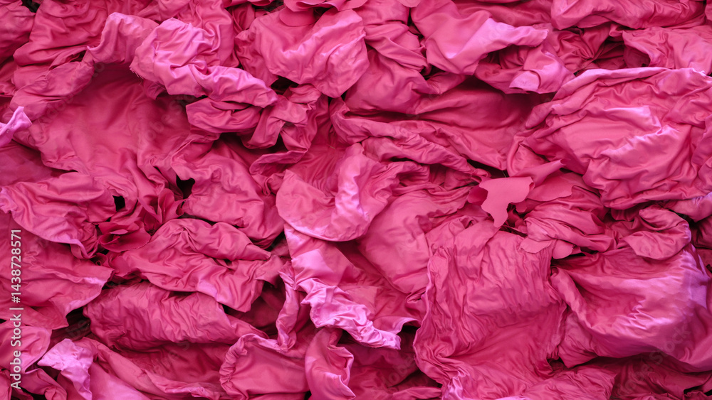 Poster pink tissue paper with a lot of folds and creases. the image has a lot of pink and the texture is ve