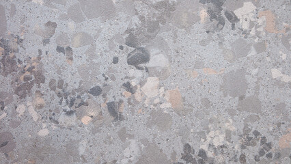 Gray black stone wall with many brown and blue structures as abstract rough textured background for page and banner templates.