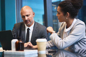 Business, people and office with laptop for strategy or planning with reports or review for company finances. Partners, employees and night in boardroom with teamwork for deadline and overtime