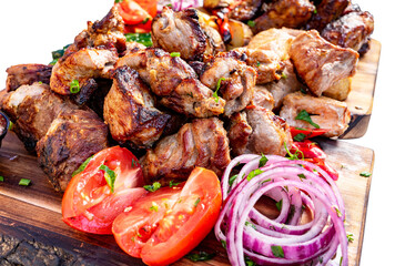 Delicious grilled meats served with fresh vegetables at a feast