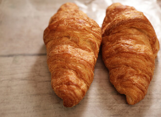 fresh croissant on wooden table