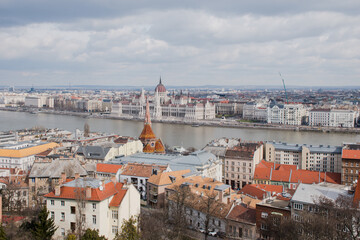 Fototapeta premium A panoramic view of the city of Budapest in Hungary over the river Danube as seen from Buda Castle; with the parliament building.