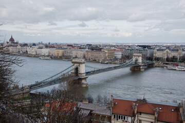 Obraz premium A panoramic view of the city of Budapest in Hungary over the river Danube with the Széchenyi Chain Bridge as seen from Buda Castle.