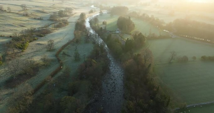 Aerial shot of a sunrise over river Ure.