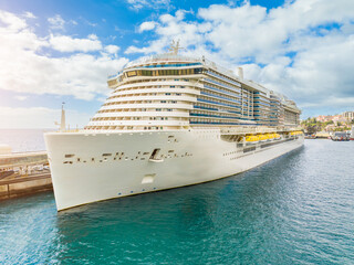 Luxurious cruise ship sailing through azure waters on a perfect sunny day, offering unforgettable...